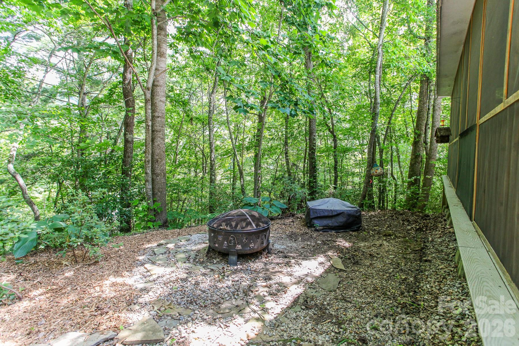 292 Wolf Creek Heights Road Almond, NC 28702 - Photo 37 of 47 a view of a backyard with table and chairs