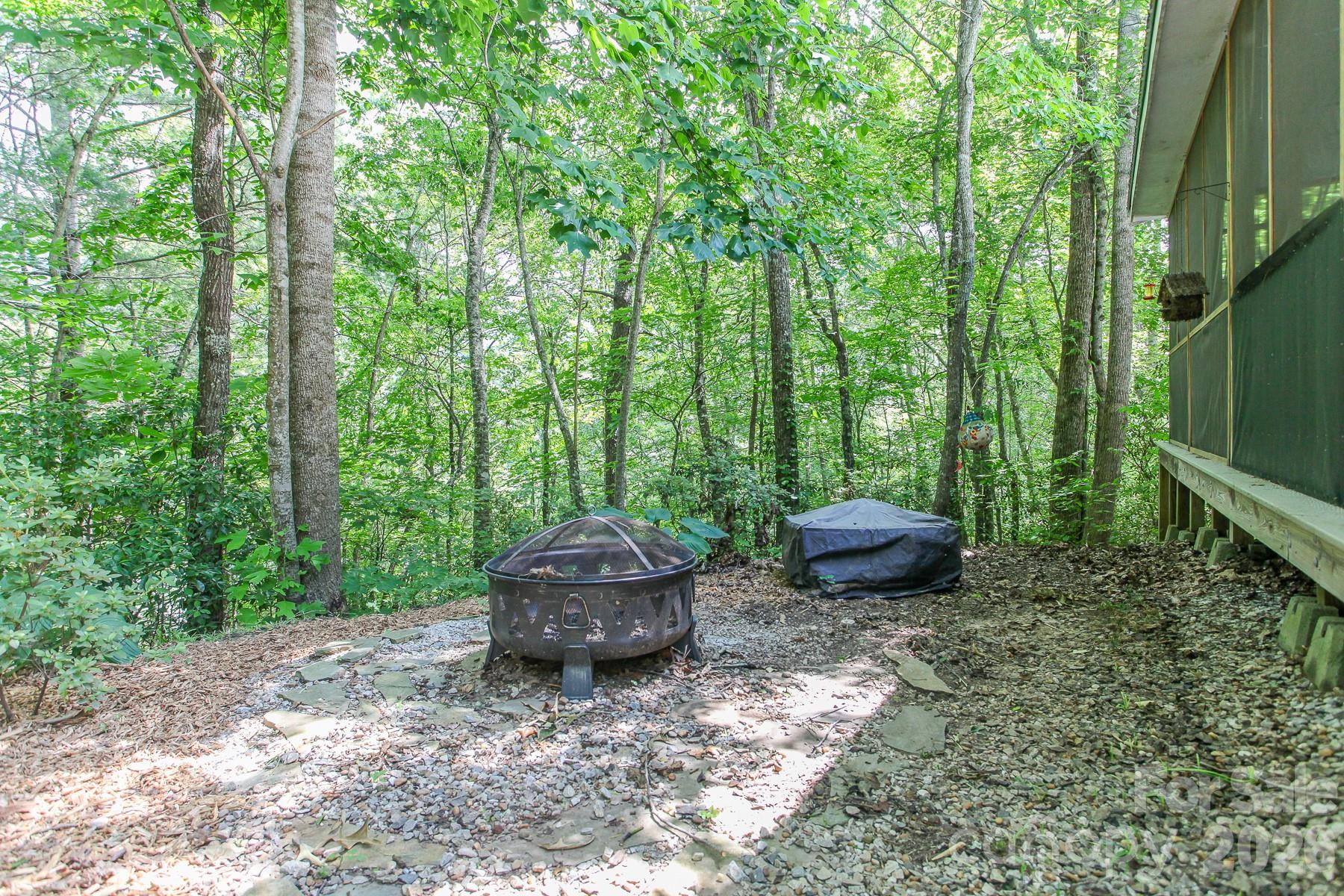 292 Wolf Creek Heights Road Almond, NC 28702 - Photo 38 of 47 a view of a backyard with table and chairs