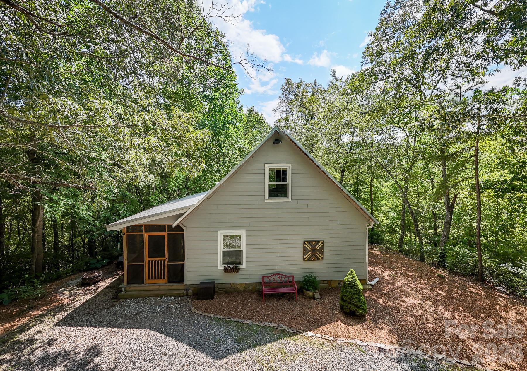 292 Wolf Creek Heights Road Almond, NC 28702 - Photo 4 of 47 a view of a house with yard and a garden