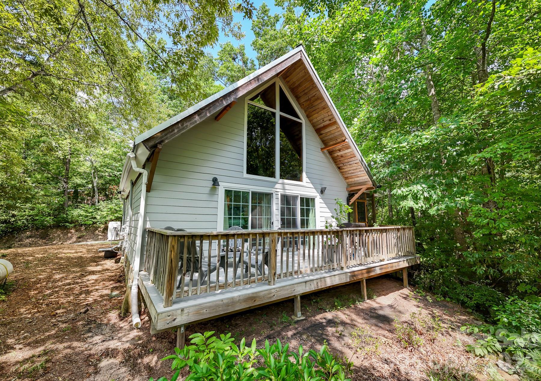 292 Wolf Creek Heights Road Almond, NC 28702 - Photo 44 of 47 a view of a wooden deck with a yard