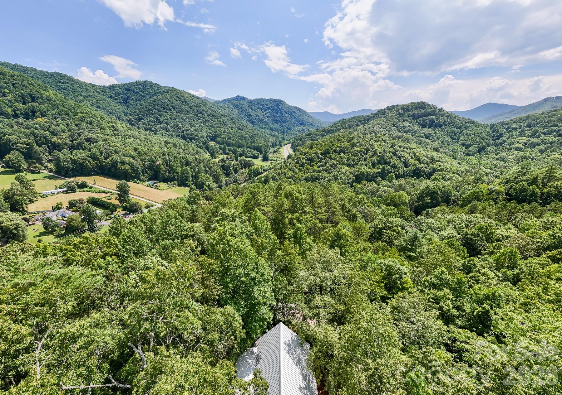 292 Wolf Creek Heights Road Almond, NC 28702 - Photo 45 of 47 a aerial view of a house with a lush green forest