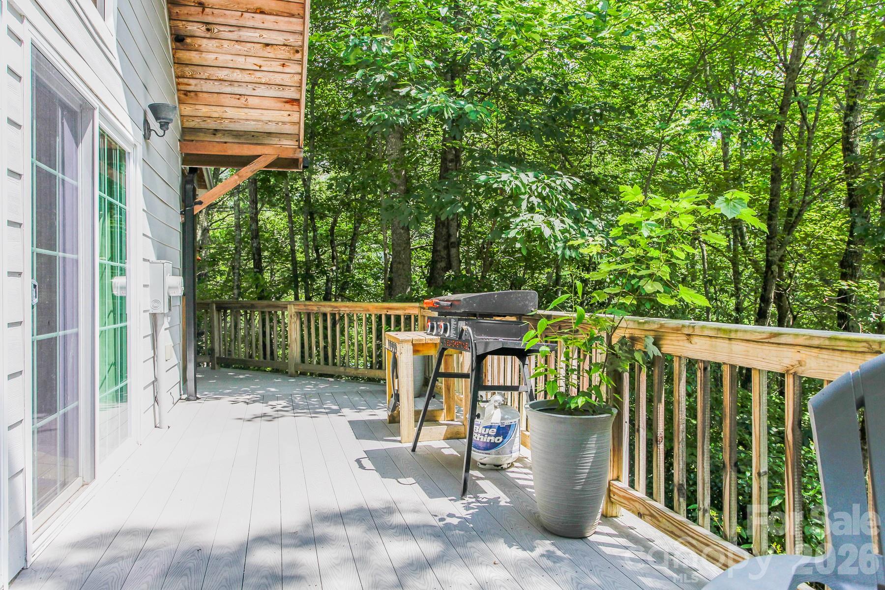 292 Wolf Creek Heights Road Almond, NC 28702 - Photo 6 of 47 a view of a patio with a table and chairs