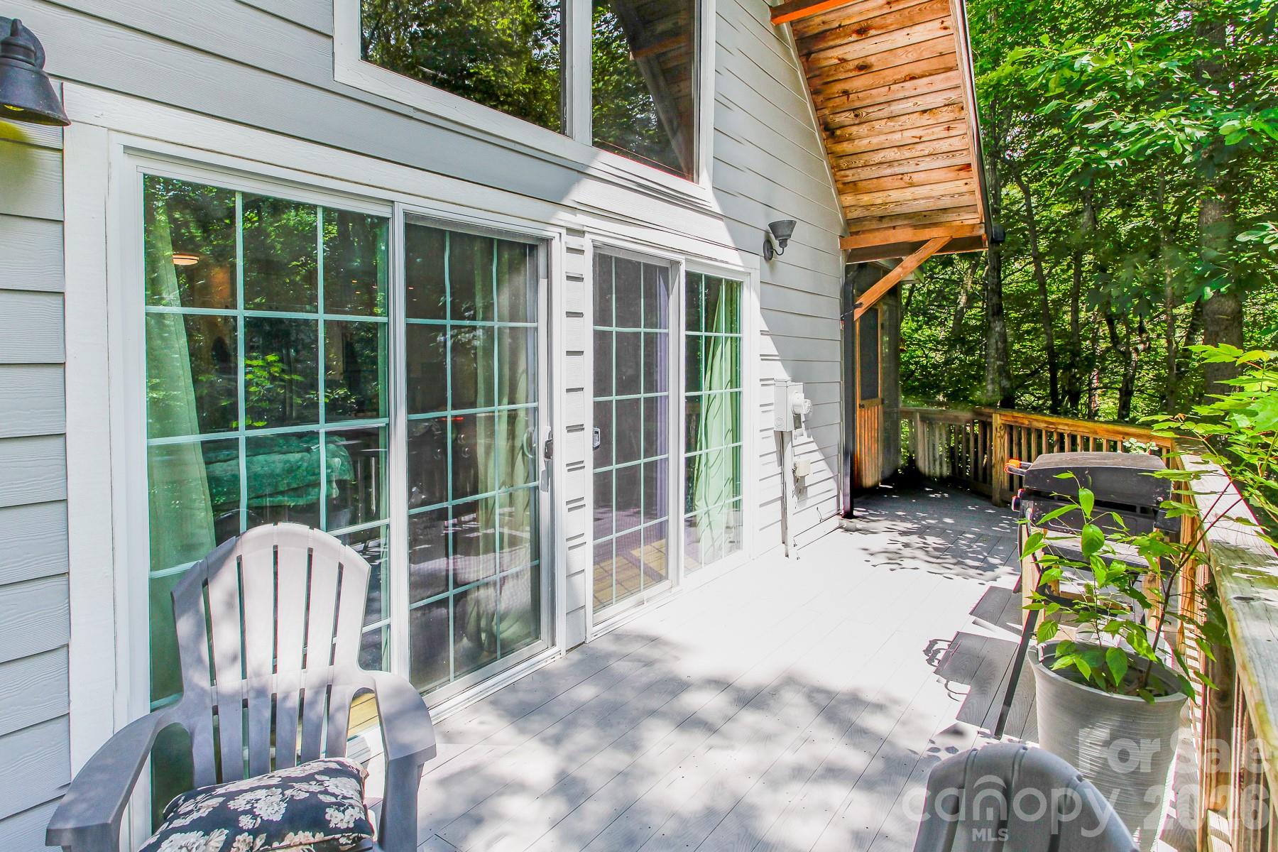 292 Wolf Creek Heights Road Almond, NC 28702 - Photo 7 of 47 a view of a chair and table in the back yard of the house