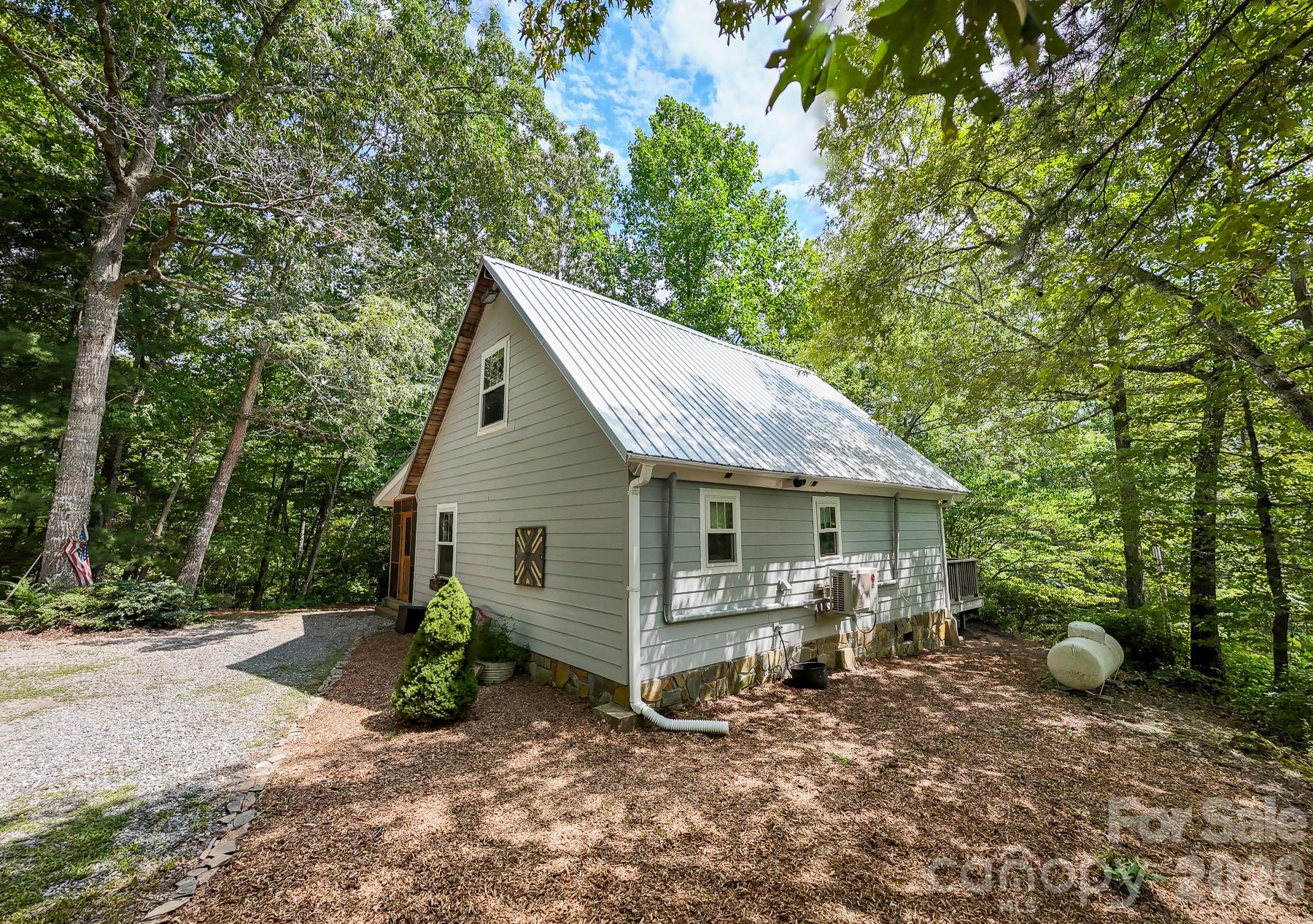292 Wolf Creek Heights Road Almond, NC 28702 - Photo 8 of 47 a view of a house with a yard and large trees