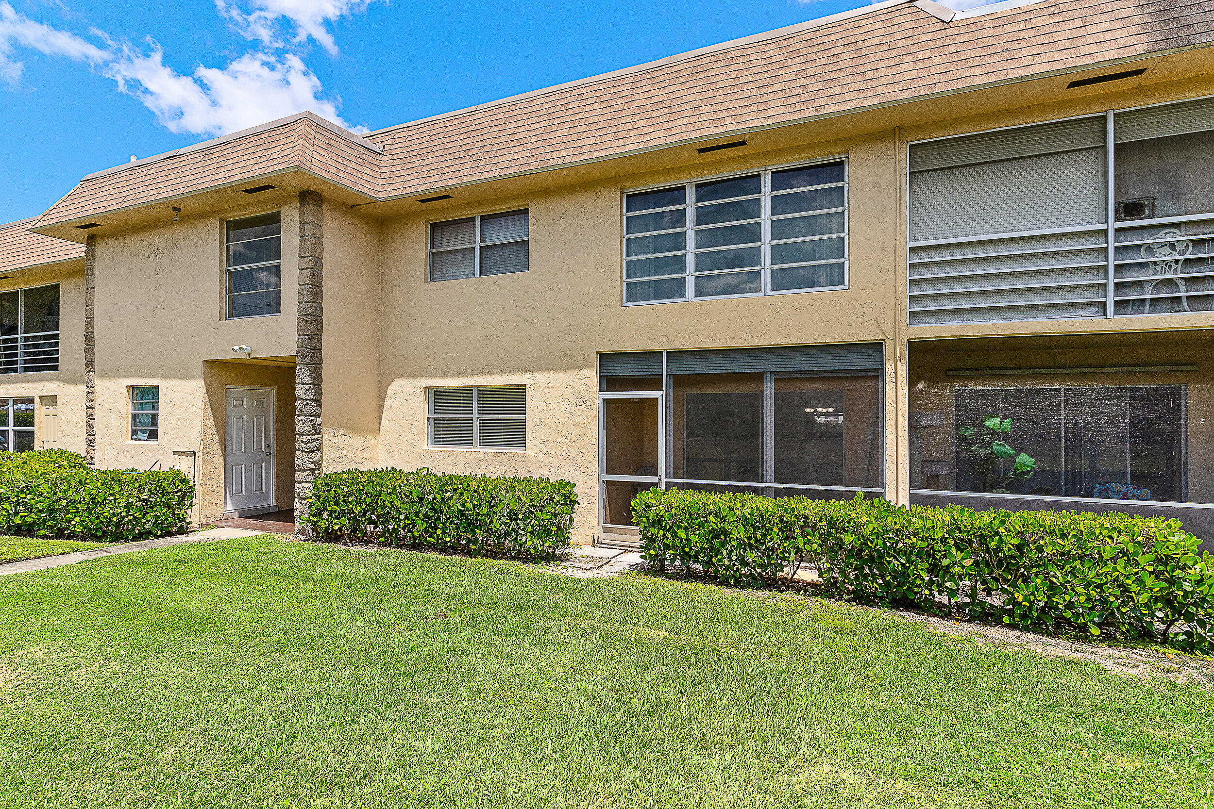 9855 Sandalfoot Boulevard, Unit 305 Boca Raton, FL 33428 - Photo 12 of 17 a view of a house with a garden