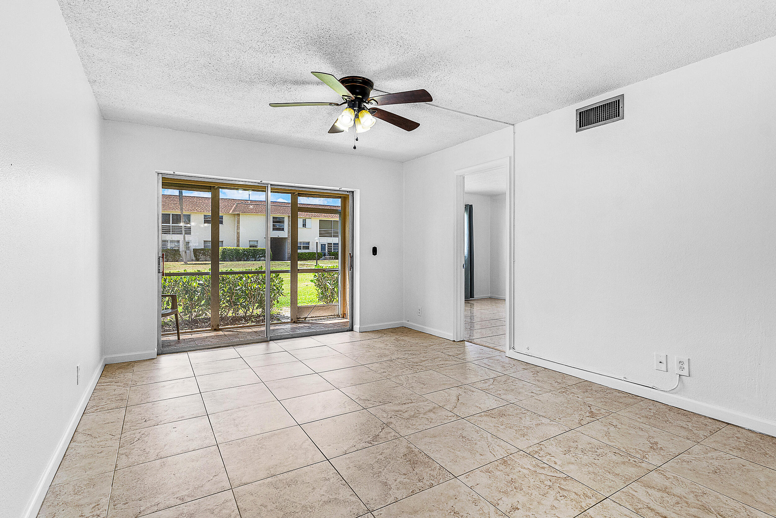 9855 Sandalfoot Boulevard, Unit 305 Boca Raton, FL 33428 - Photo 3 of 17 a view of an empty room with a window