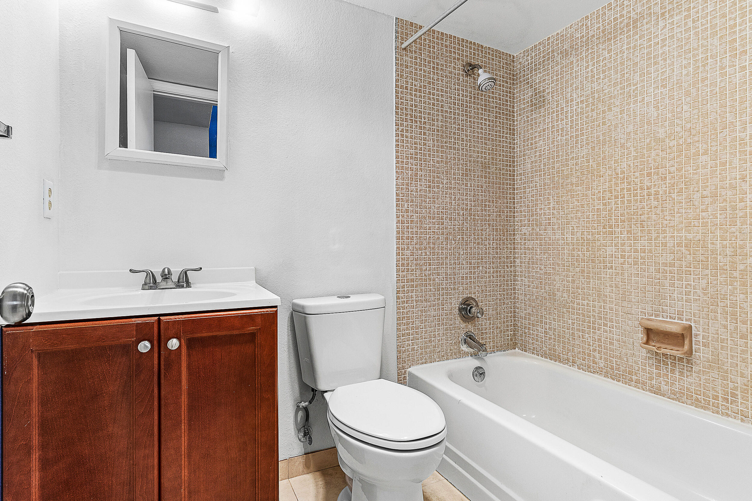 9855 Sandalfoot Boulevard, Unit 305 Boca Raton, FL 33428 - Photo 10 of 17 a bathroom with a sink a toilet and shower