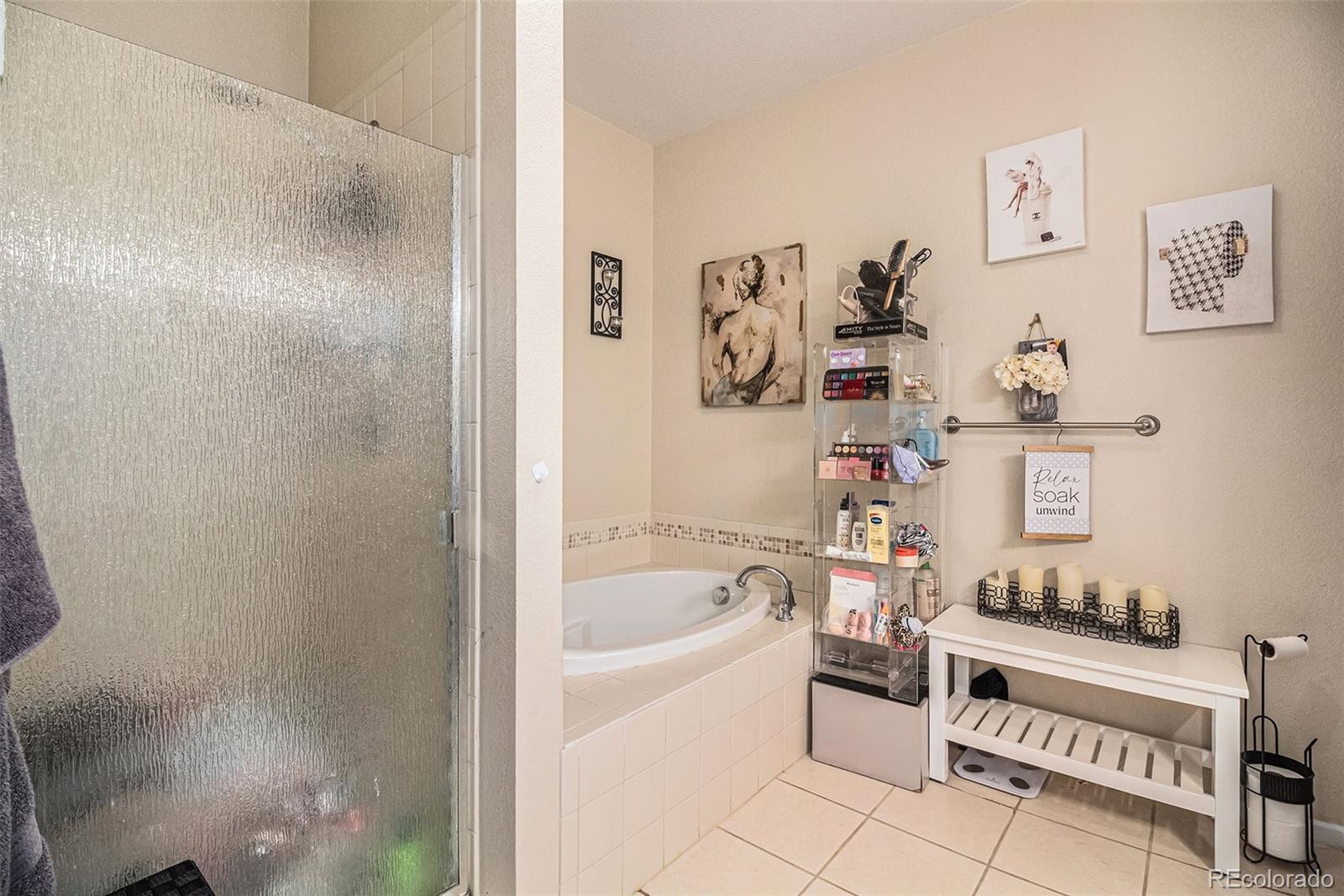 10818 Cimarron Street, Unit 1202 Firestone, CO 80504 - Photo 6 of 13 a bathroom with a bathtub and a window