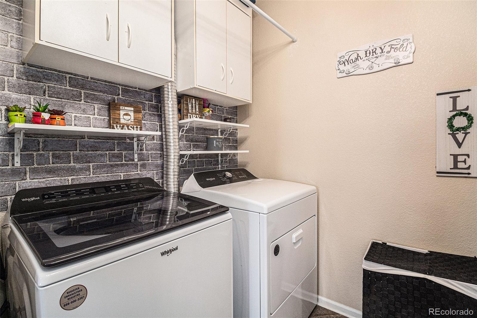 10818 Cimarron Street, Unit 1202 Firestone, CO 80504 - Photo 10 of 13 a utility room with dryer and washer