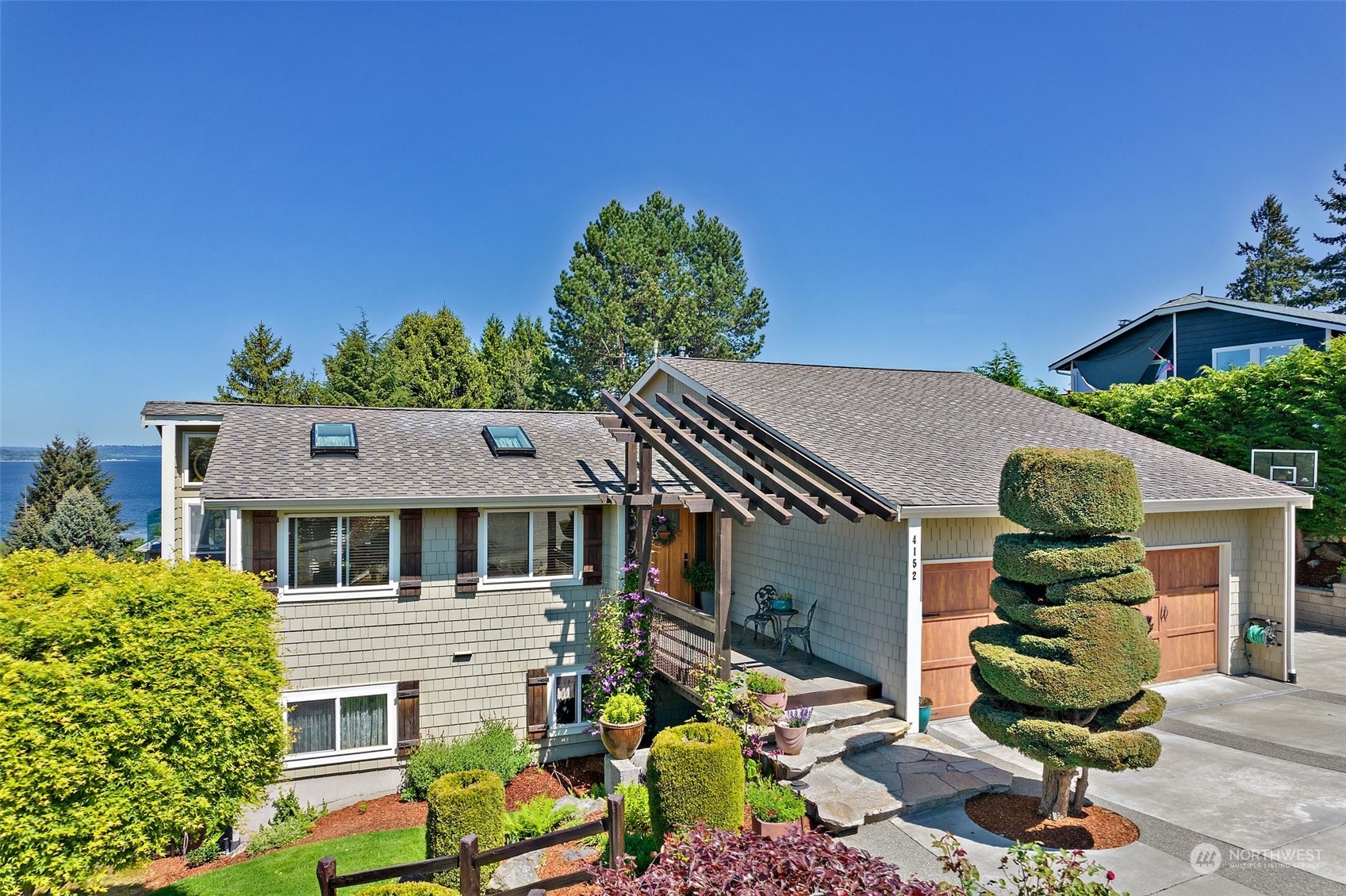 a aerial view of a house with a yard and potted plants