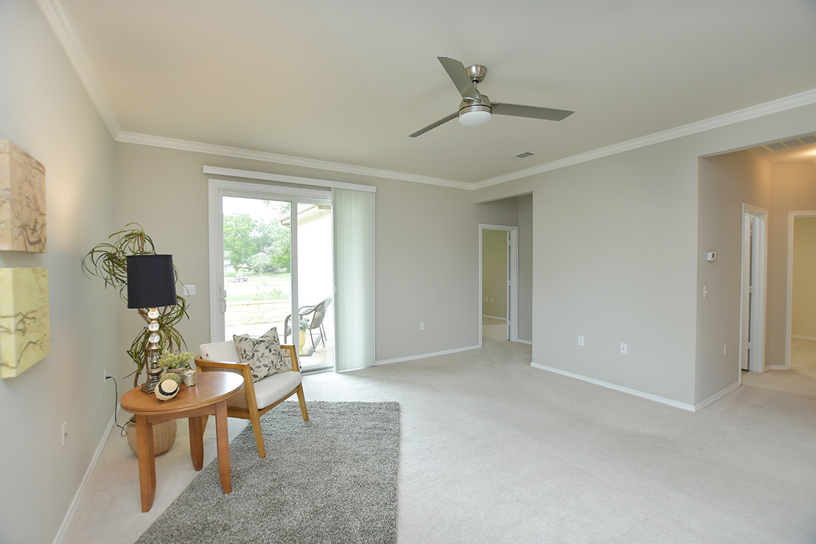 203 Winter Drive Georgetown, TX 78633 - Photo 12 of 29 Two hallways off the living area - one goes to the two guest bedrooms and the other to the primary bedroom at the rear of the home.