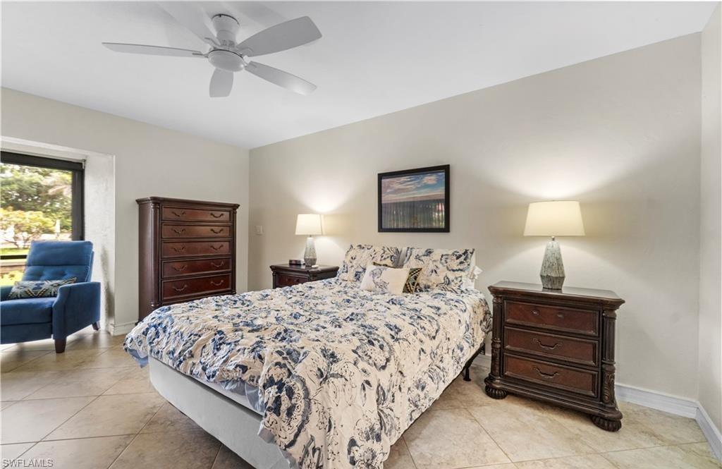 5890 Via Lugano, Unit 101 Naples, FL 34108 - Photo 12 of 22 a bedroom with a bed and furniture