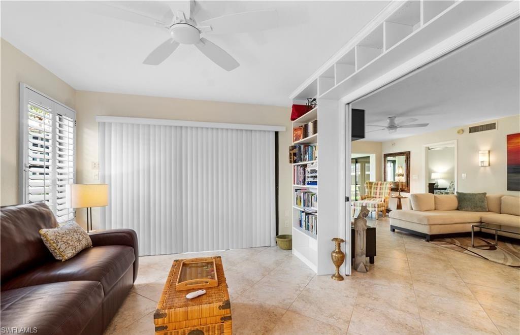 5890 Via Lugano, Unit 101 Naples, FL 34108 - Photo 16 of 22 a living room with furniture and a flat screen tv