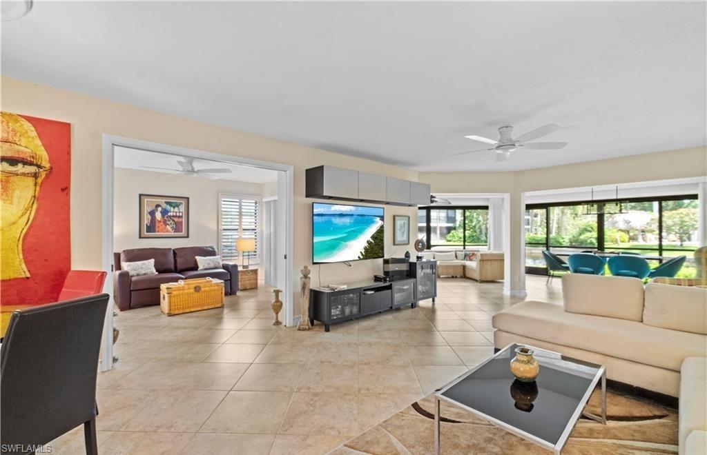 5890 Via Lugano, Unit 101 Naples, FL 34108 - Photo 2 of 22 a living room with furniture and a flat screen tv