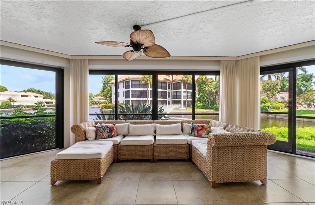 5890 Via Lugano, Unit 101 Naples, FL 34108 - Photo 8 of 22 a living room with furniture and a large window