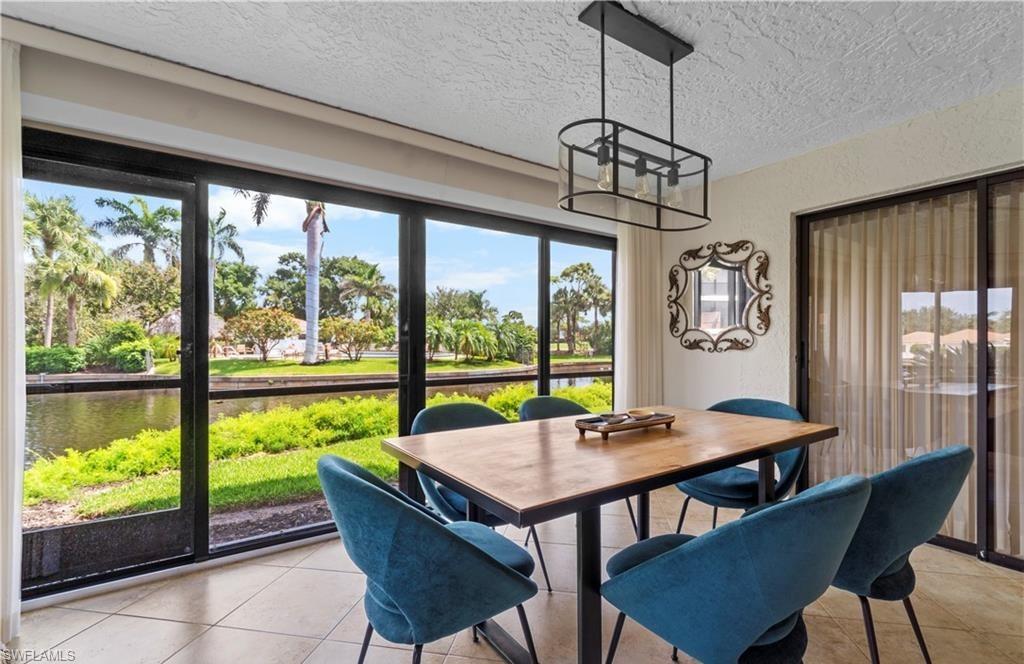 5890 Via Lugano, Unit 101 Naples, FL 34108 - Photo 9 of 22 a view of a dining room with furniture window and outside view