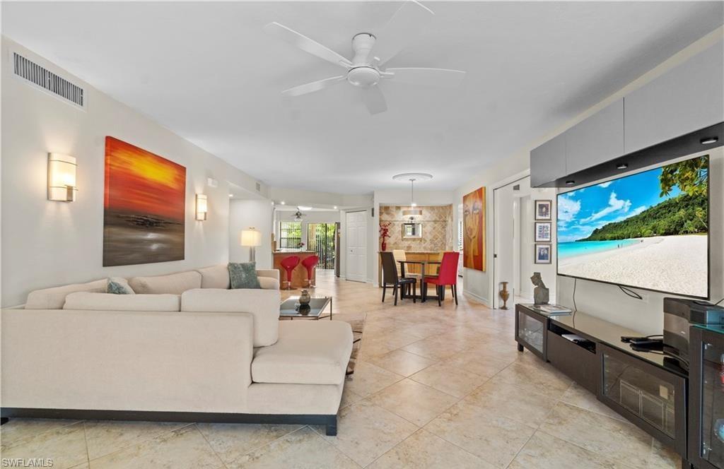 5890 Via Lugano, Unit 101 Naples, FL 34108 - Photo 10 of 22 a living room with furniture and a flat screen tv