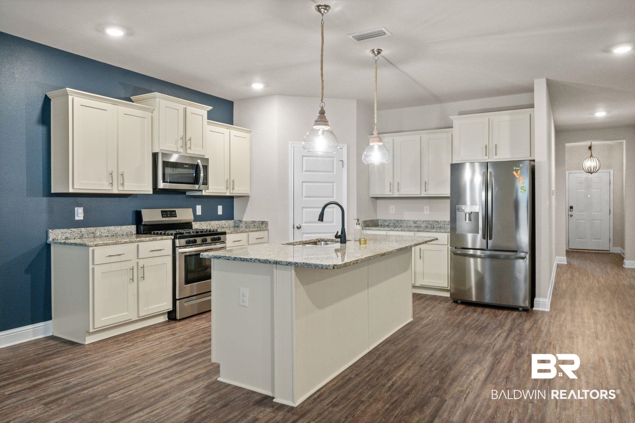 24769 Slater Mill Road Daphne, AL 36526 - Photo 10 of 38 Kitchen with a center island with sink, sink, dark hardwood / wood-style flooring, and stainless steel appliances