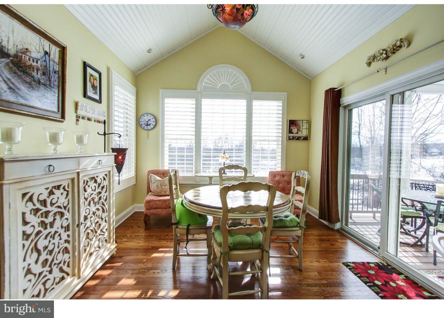5237 Windtree Drive Doylestown, PA 18902 - Photo 11 of 25 a dining room with furniture a chandelier and wooden floor