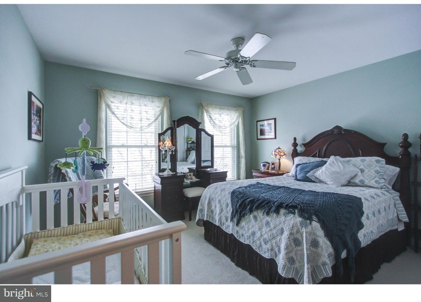 5237 Windtree Drive Doylestown, PA 18902 - Photo 17 of 25 a bedroom with a bed a chandelier and windows