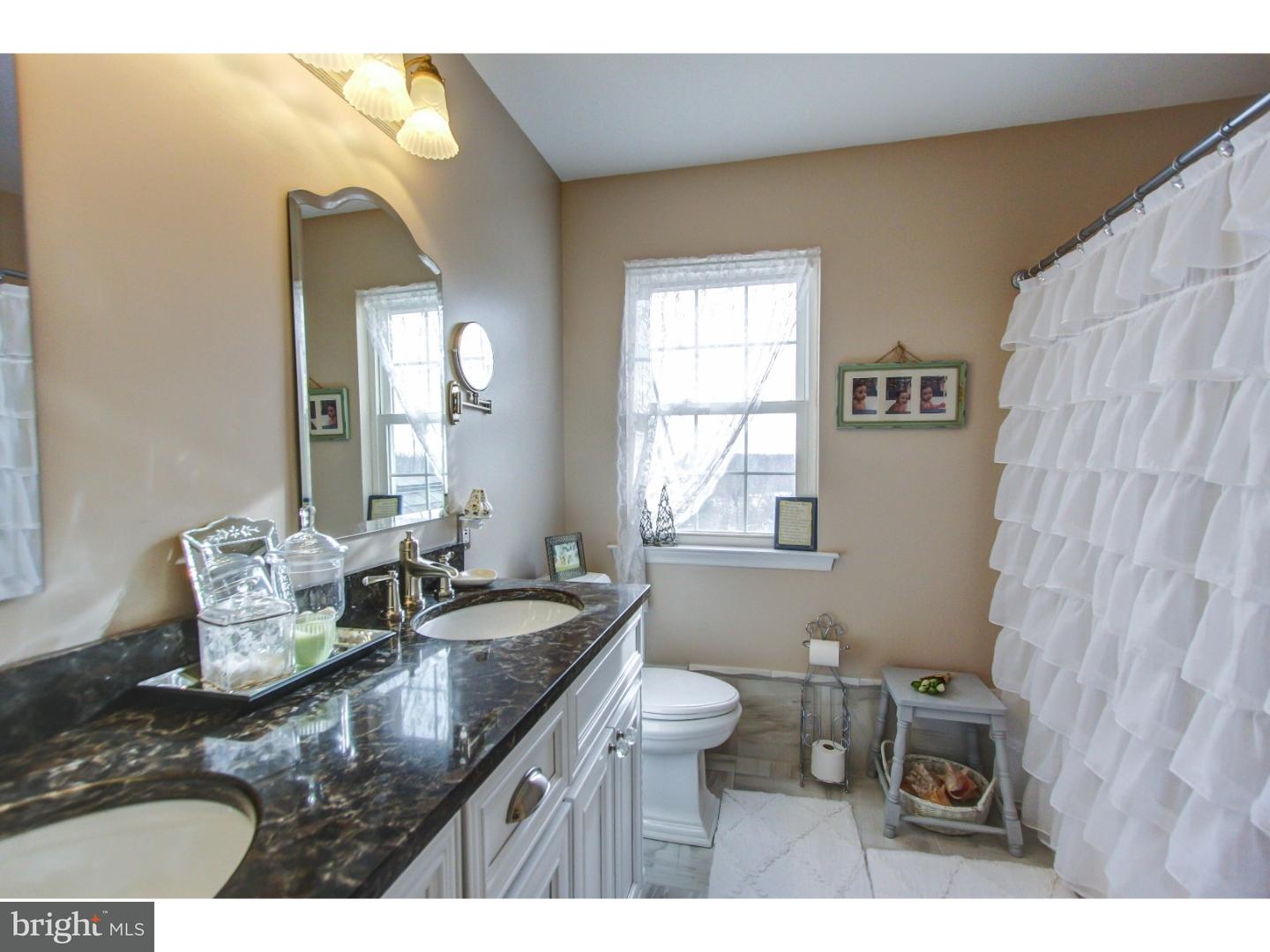 5237 Windtree Drive Doylestown, PA 18902 - Photo 18 of 25 a bathroom with a granite countertop sink and a mirror