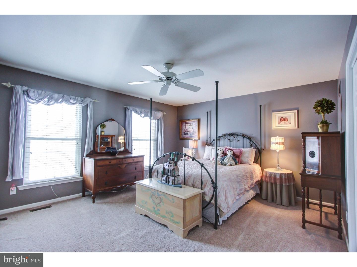 5237 Windtree Drive Doylestown, PA 18902 - Photo 19 of 25 a living room with furniture a ceiling fan and a window