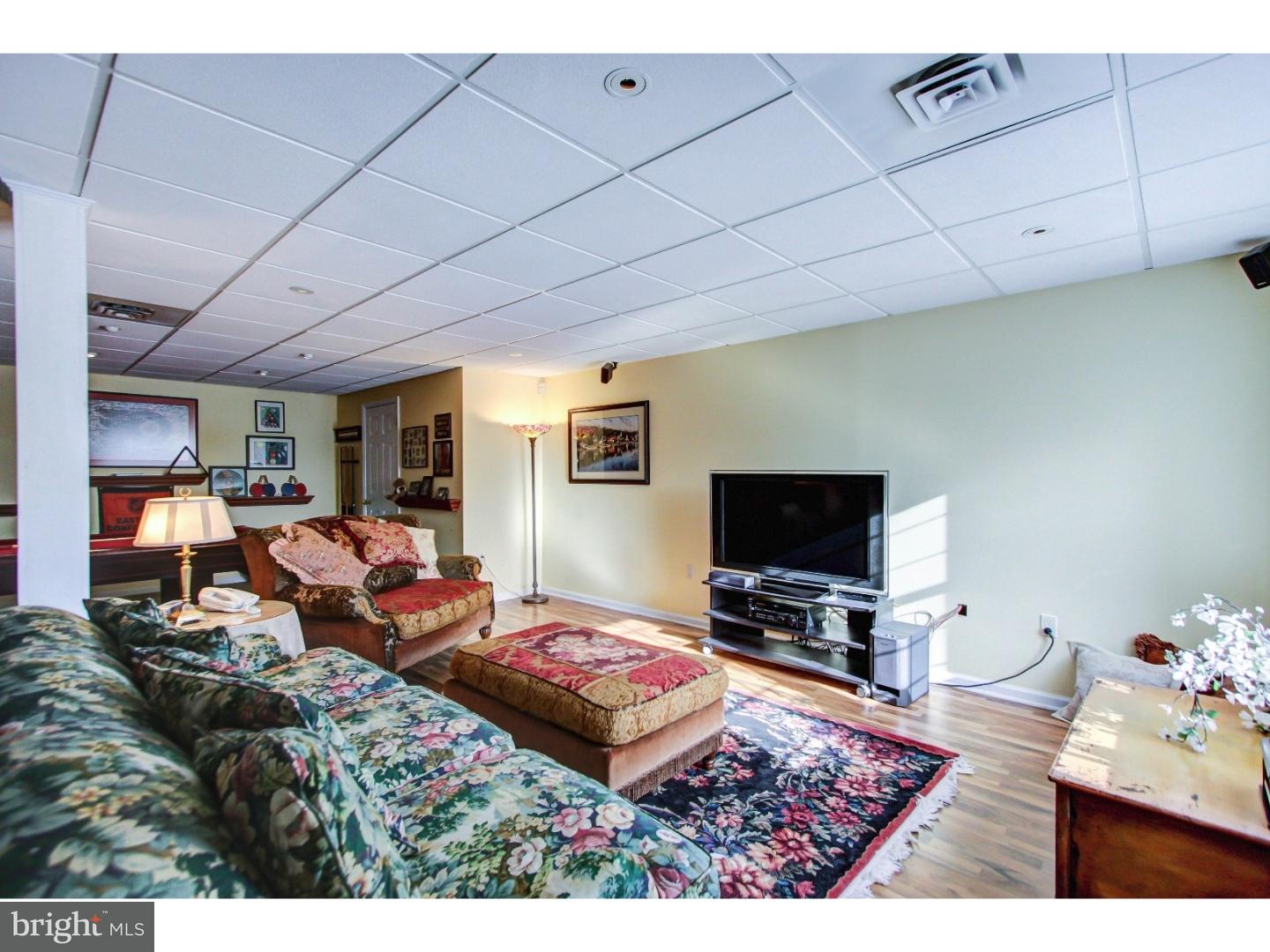 5237 Windtree Drive Doylestown, PA 18902 - Photo 21 of 25 a living room with furniture and a flat screen tv