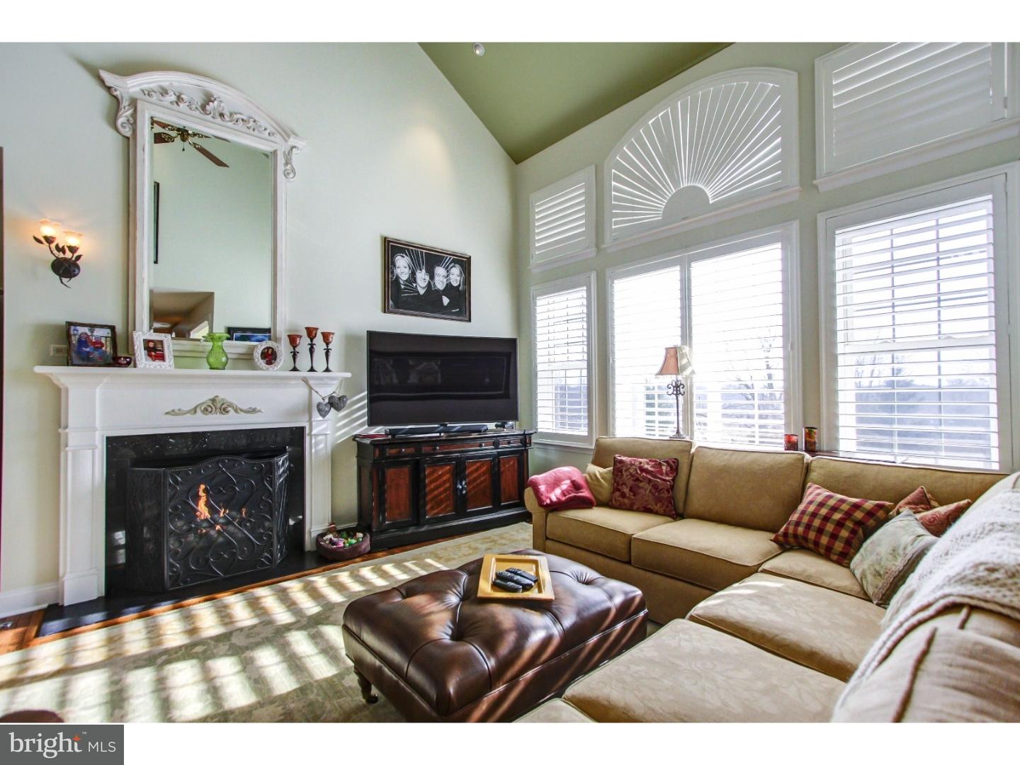 5237 Windtree Drive Doylestown, PA 18902 - Photo 7 of 25 a living room with furniture a flat screen tv and a fireplace