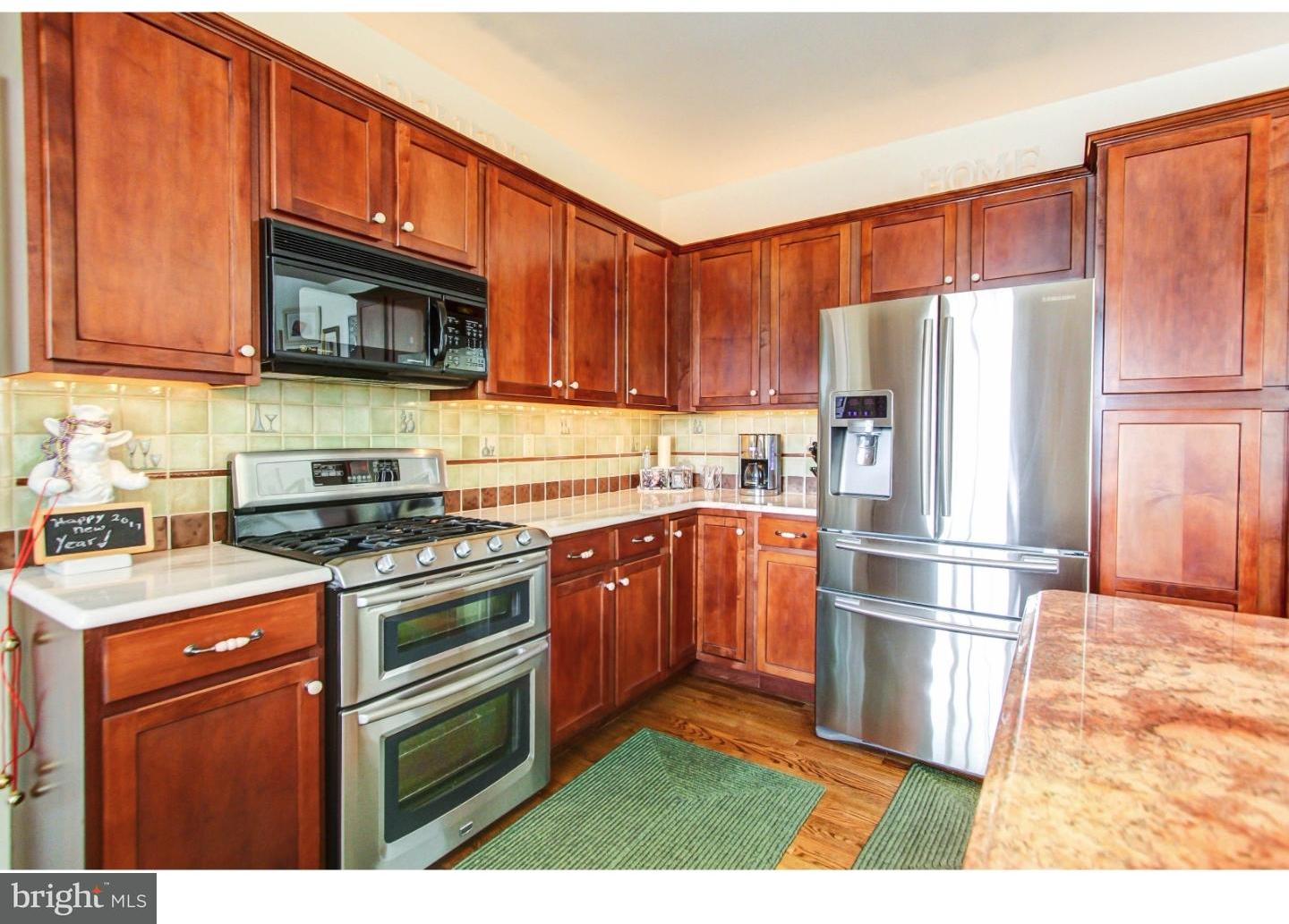 5237 Windtree Drive Doylestown, PA 18902 - Photo 10 of 25 a kitchen with stainless steel appliances granite countertop a refrigerator stove a sink and a microwave