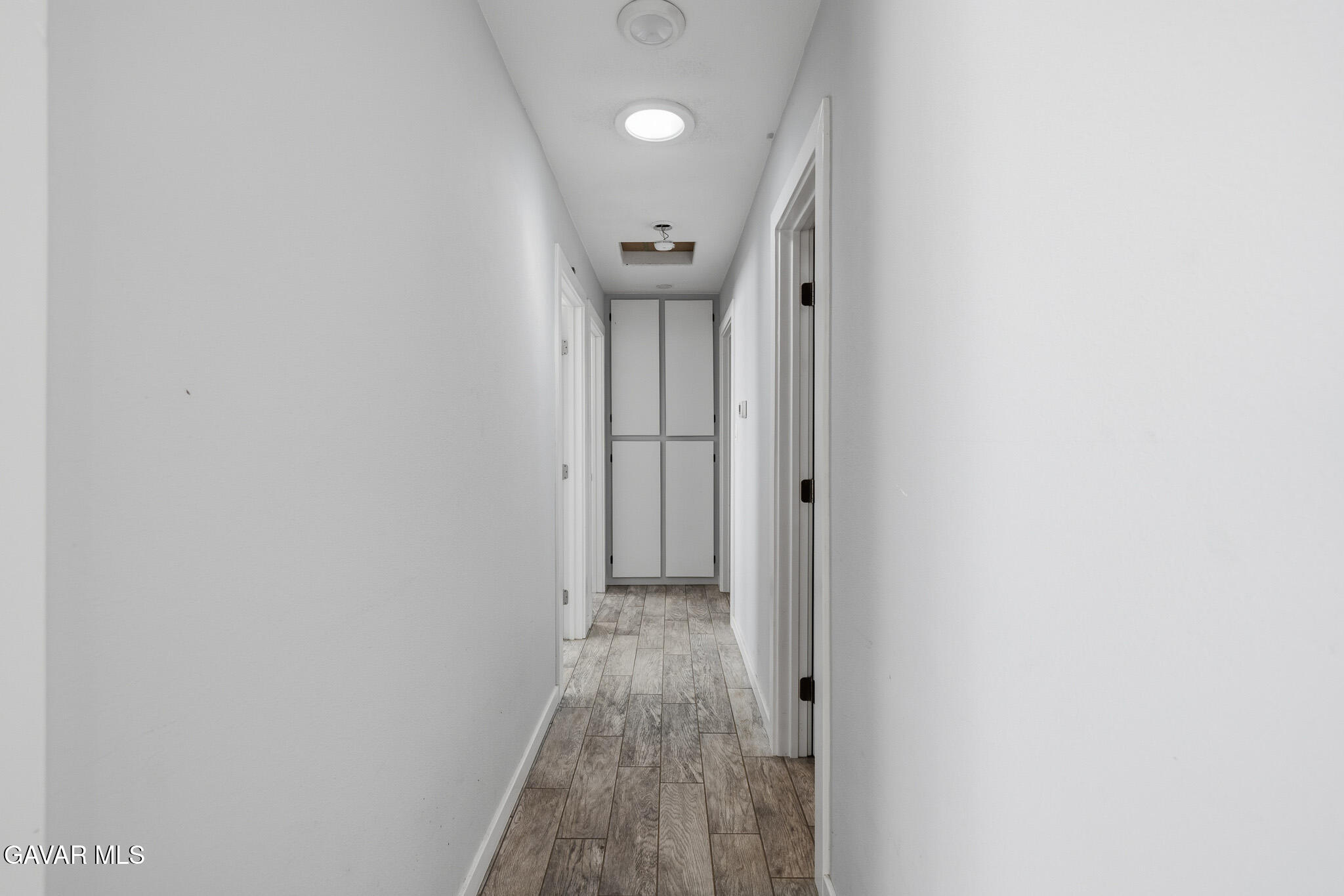 10817 East Ave R 12 Littlerock, CA 93543 - Photo 16 of 43 a view of a hallway with wooden floor
