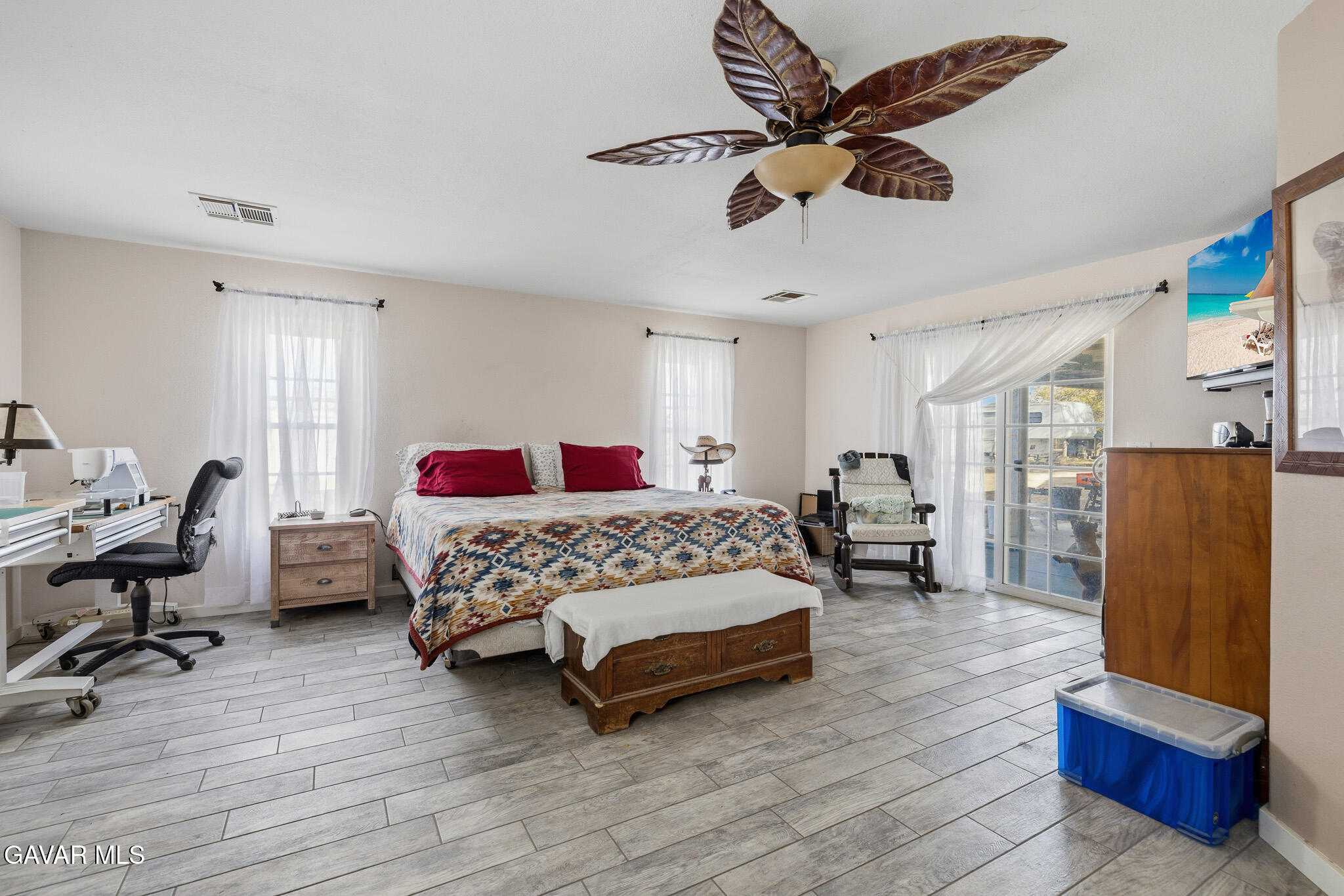 10817 East Ave R 12 Littlerock, CA 93543 - Photo 21 of 43 a bedroom with a bed and wooden floor