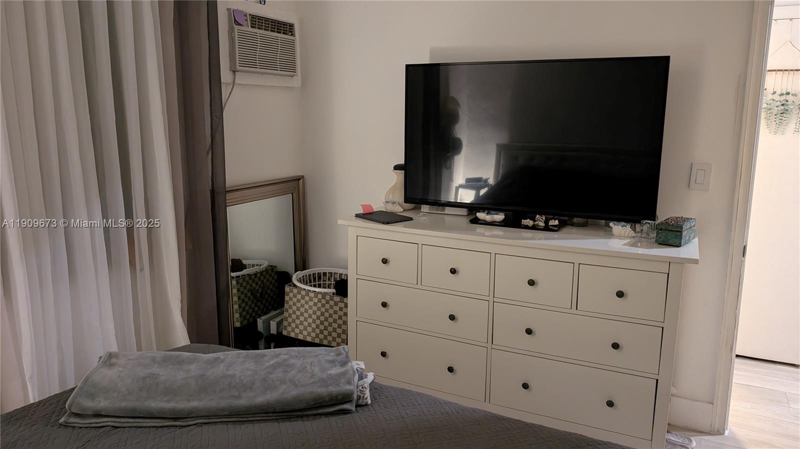917-919 Northeast 10th Street Hallandale Beach, FL 33009 - Photo 4 of 10 a living room with couch and flat screen tv