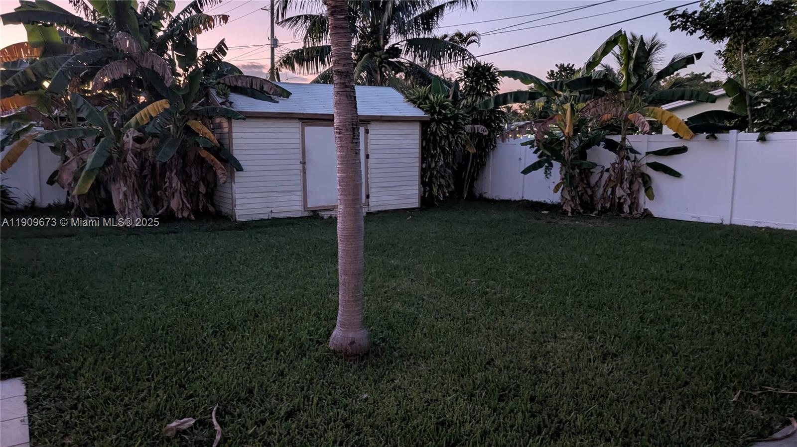 917-919 Northeast 10th Street Hallandale Beach, FL 33009 - Photo 10 of 10 a house that has a tree in front of it