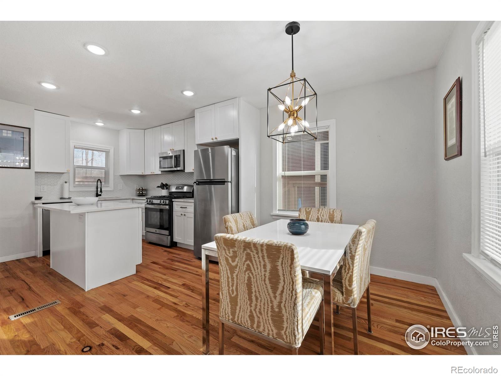 814 West Laurel Street Fort Collins, CO 80521 - Photo 12 of 35 a kitchen with a refrigerator a stove a sink dishwasher with a dining table and chairs