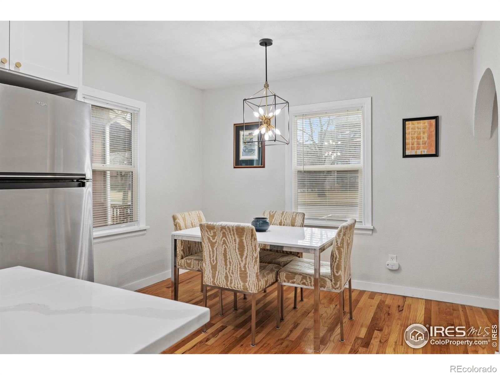 814 West Laurel Street Fort Collins, CO 80521 - Photo 15 of 35 a dining room with wooden floor a chandelier a wooden table and chairs