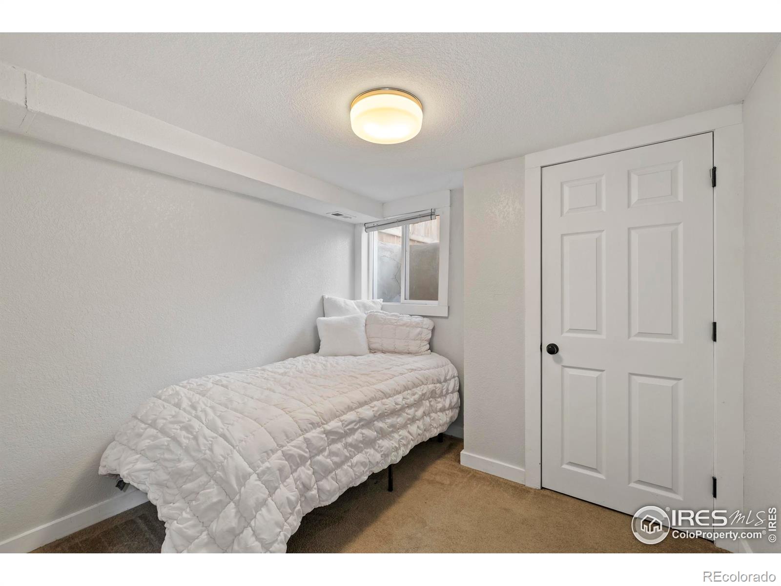 814 West Laurel Street Fort Collins, CO 80521 - Photo 21 of 35 a bedroom with a bed and a view of living room