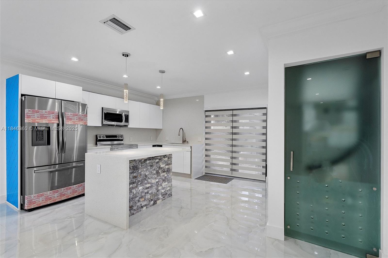 501 East 59th Street Hialeah, FL 33013 - Photo 11 of 29 a kitchen with stainless steel appliances a refrigerator and a stove top oven