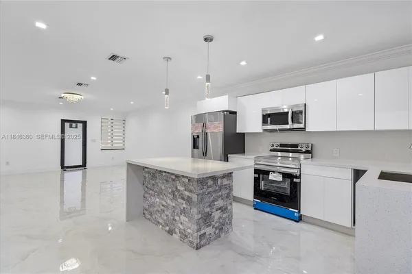 a view of a kitchen with a sink and a refrigerator