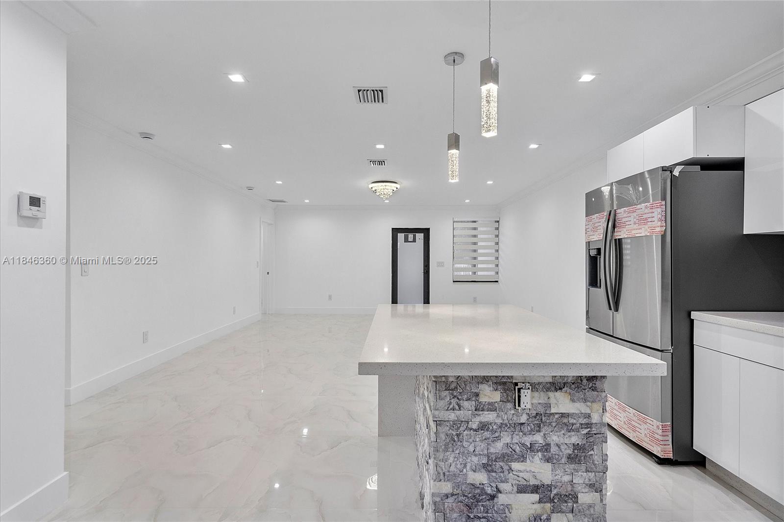 501 East 59th Street Hialeah, FL 33013 - Photo 13 of 29 a view of a kitchen with a sink and a refrigerator