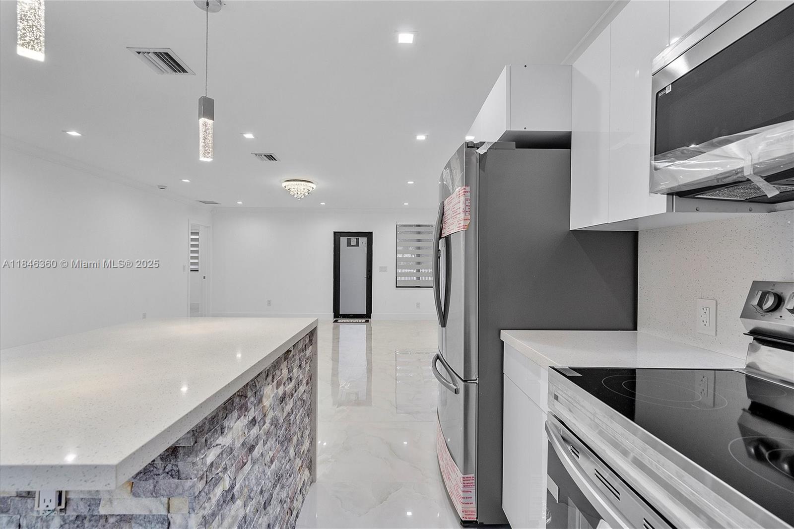 501 East 59th Street Hialeah, FL 33013 - Photo 14 of 29 a kitchen with stainless steel appliances granite countertop a sink a stove a refrigerator and a oven