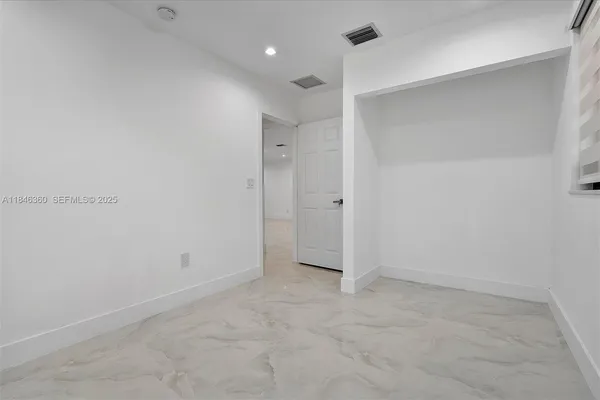 a bathroom with a sink a toilet a mirror and shower