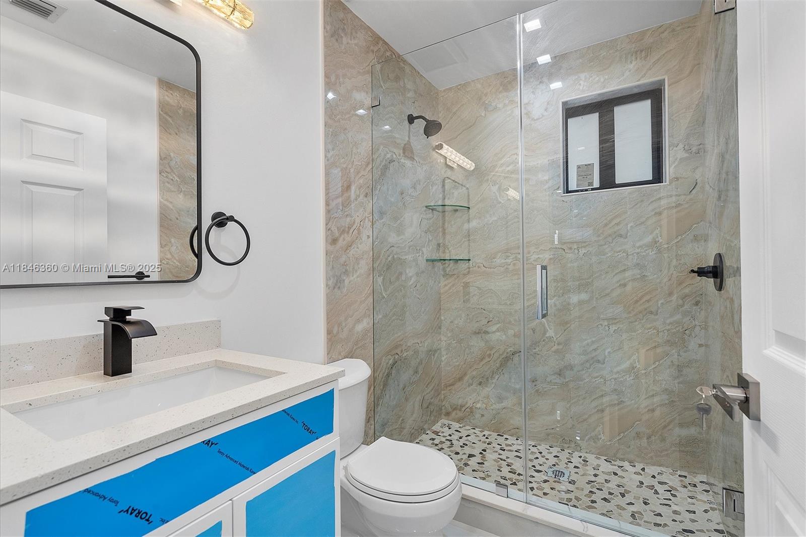 501 East 59th Street Hialeah, FL 33013 - Photo 21 of 29 a bathroom with a sink a toilet a mirror and shower