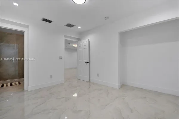 a view of an empty room with a window