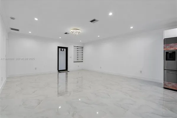 an empty room with entrance and stairs