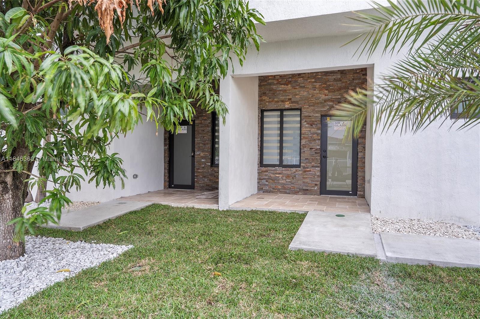 501 East 59th Street Hialeah, FL 33013 - Photo 3 of 29 a front view of a house with a garden
