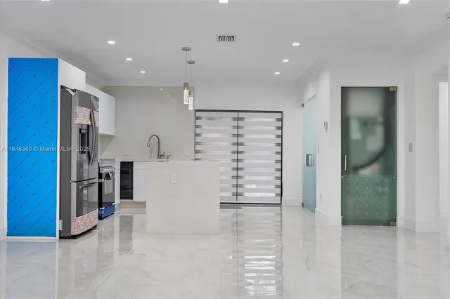 a view of kitchen with refrigerator and cabinets