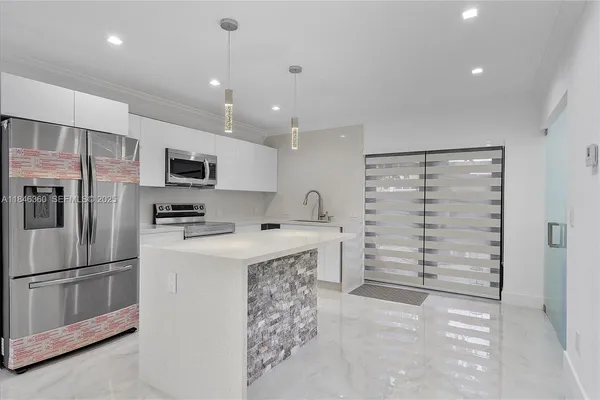 a kitchen with stainless steel appliances a refrigerator sink and cabinets