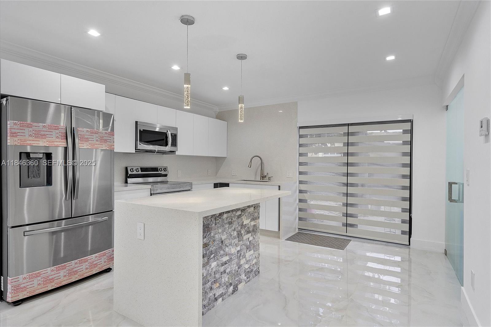 501 East 59th Street Hialeah, FL 33013 - Photo 8 of 29 a kitchen with stainless steel appliances a refrigerator sink and cabinets