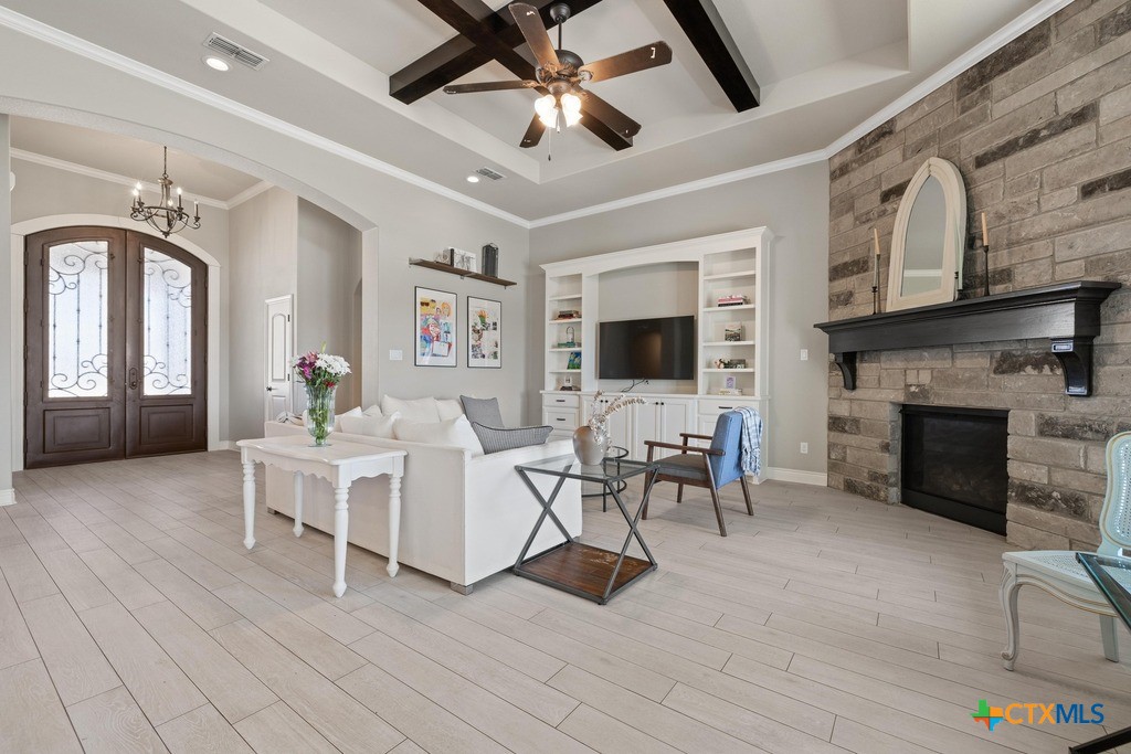 1745 Alta Vista Loop Temple, TX 76502 - Photo 6 of 34 a living room with furniture a fireplace and a flat screen tv