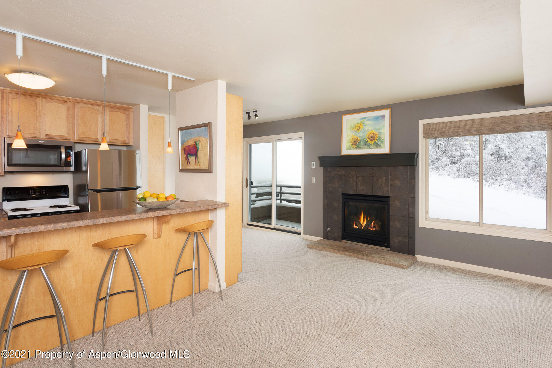 a large kitchen with cabinets and a fireplace